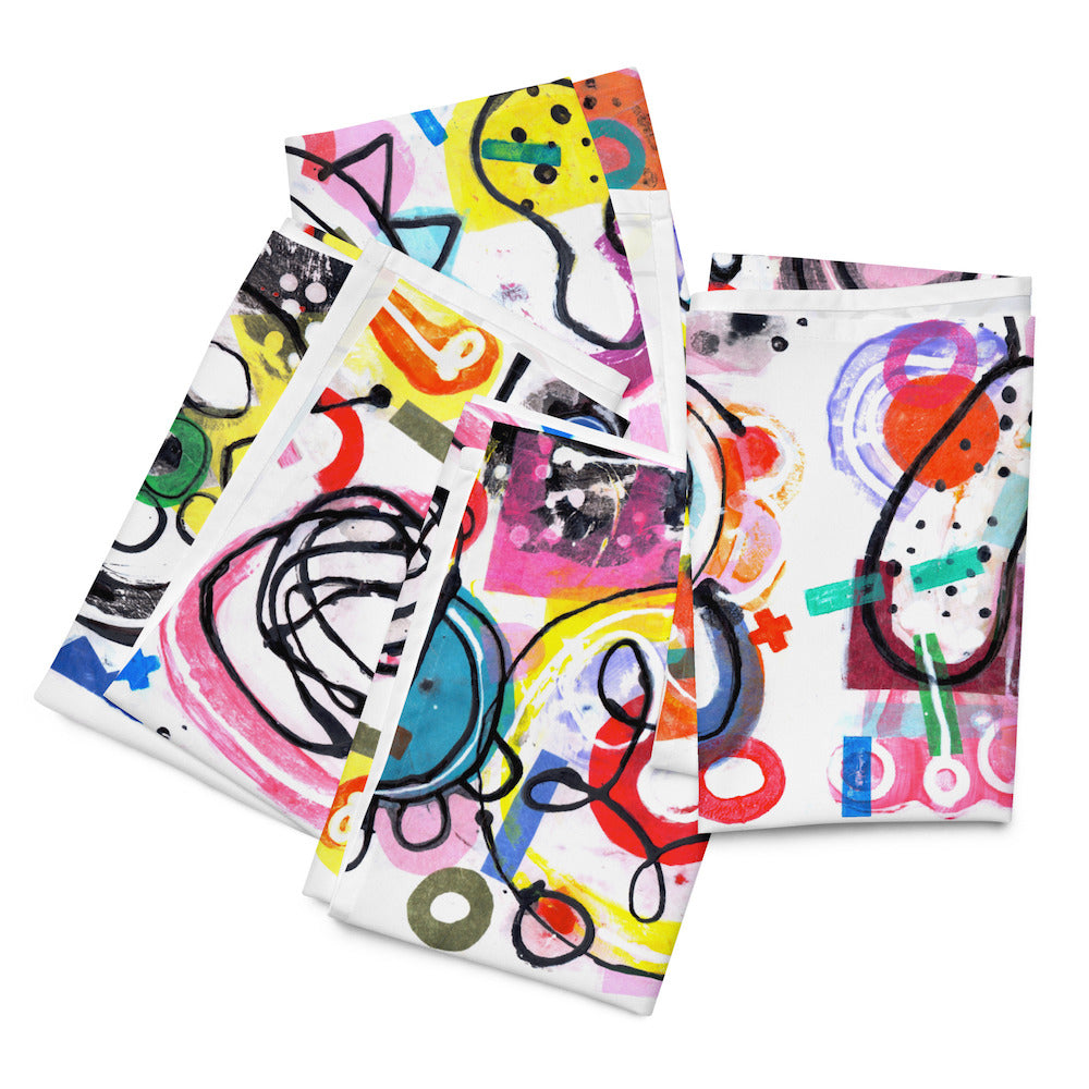 Arty graphic napkin set of four folded and stacked together with happy multicolor Treasure Map print in a vibrant, cheerful, and playful style.