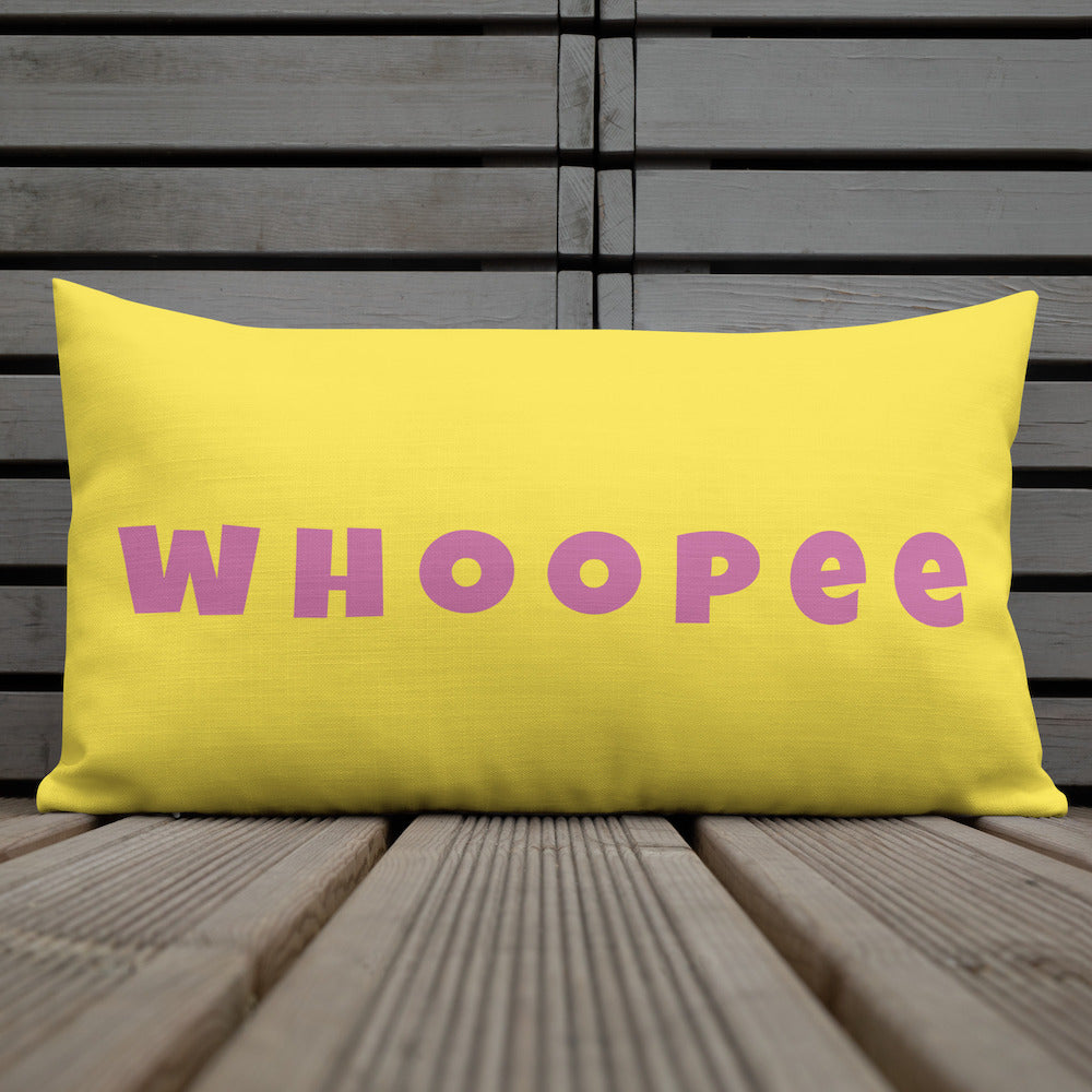 Vibrant, cheerful, and playful style accent pillow on wood deck with a fun Whoopee slogan in pink letters on yellow.