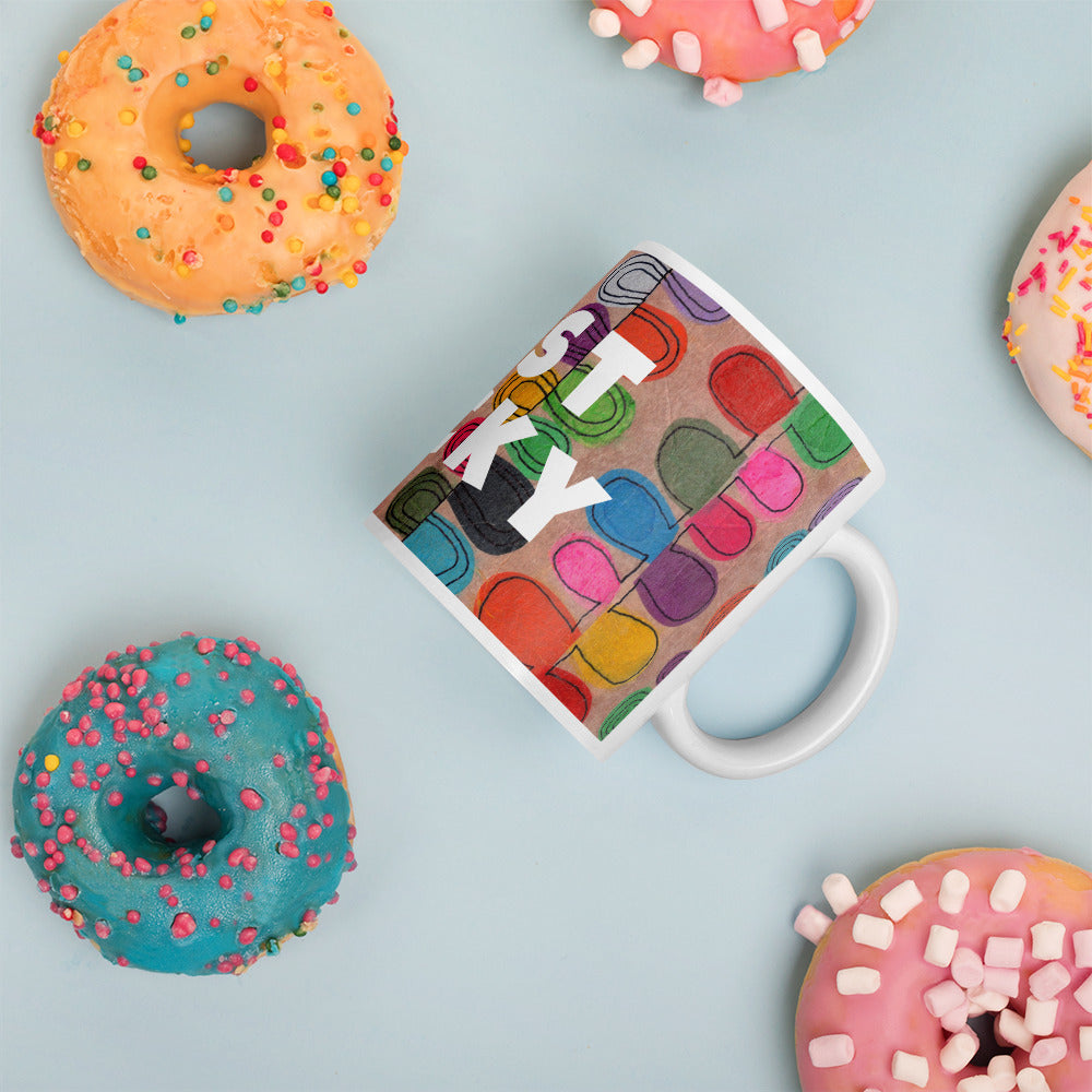 Colorful ceramic coffee mug with quirky slogan Just Ducky in white letters on Flipflop design with happy donuts right view.