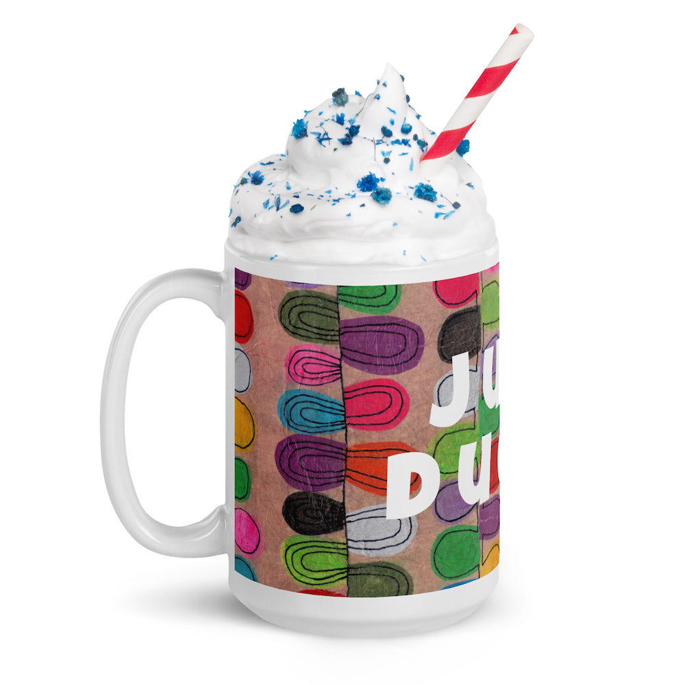 Colorful ceramic coffee mug with quirky slogan Just Ducky in white letters on Flipflop design with whipped cream left view.
