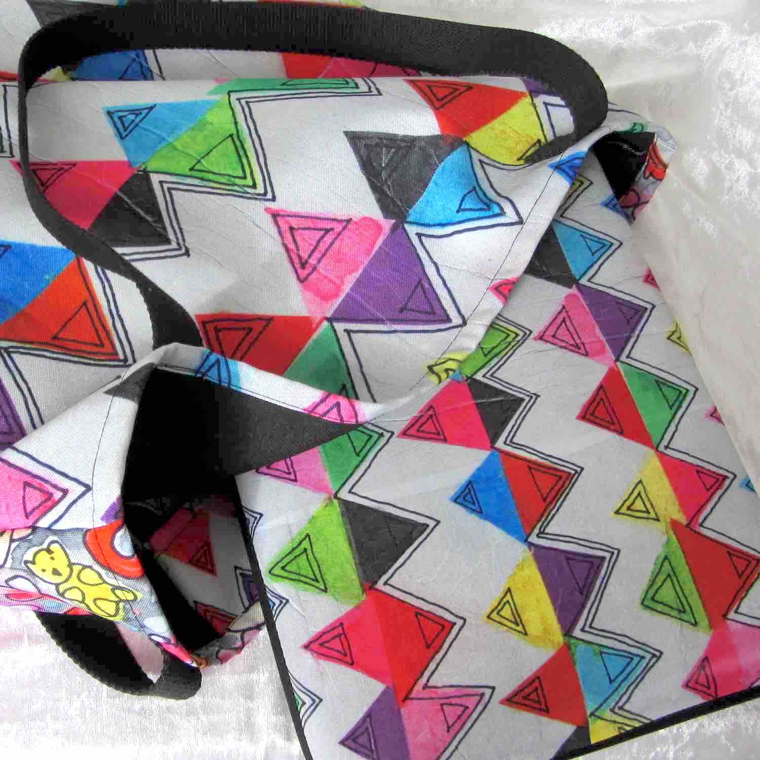 Graphic laptop case with rainbow-inspired multicolor Zigzag print in vibrant colors with matching tote bag.