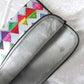 Graphic laptop case with rainbow-inspired multicolor print in Zigzag. Detail of soft furry lining in gray color.