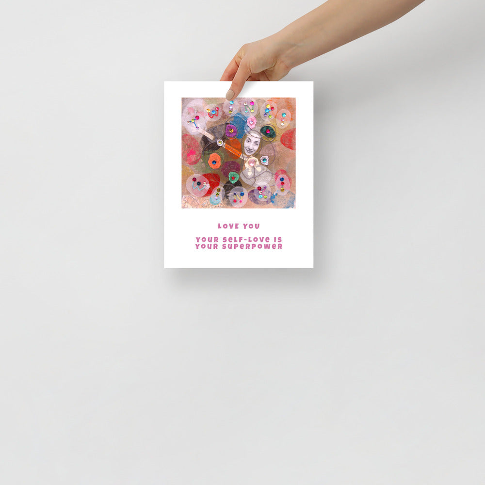 Fine art print Love You hand held against wall to show size. Alex Mitchell’s happy face surrounded by colorful shapes and textures.