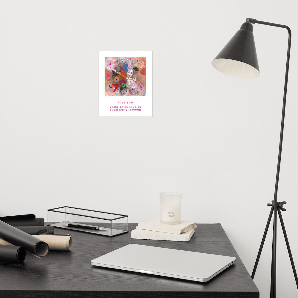 Fine art print Love You hanging on wall at modern desk area. Alex Mitchell’s happy face surrounded by colorful shapes and textures.