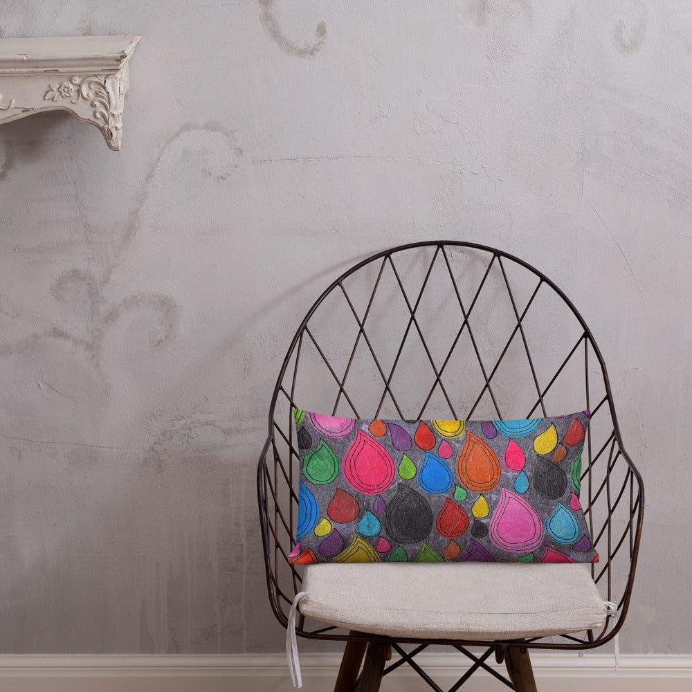 Vibrant, cheerful, and playful style accent pillow on modern chair with a multicolor graphic Dripdrop print on front.