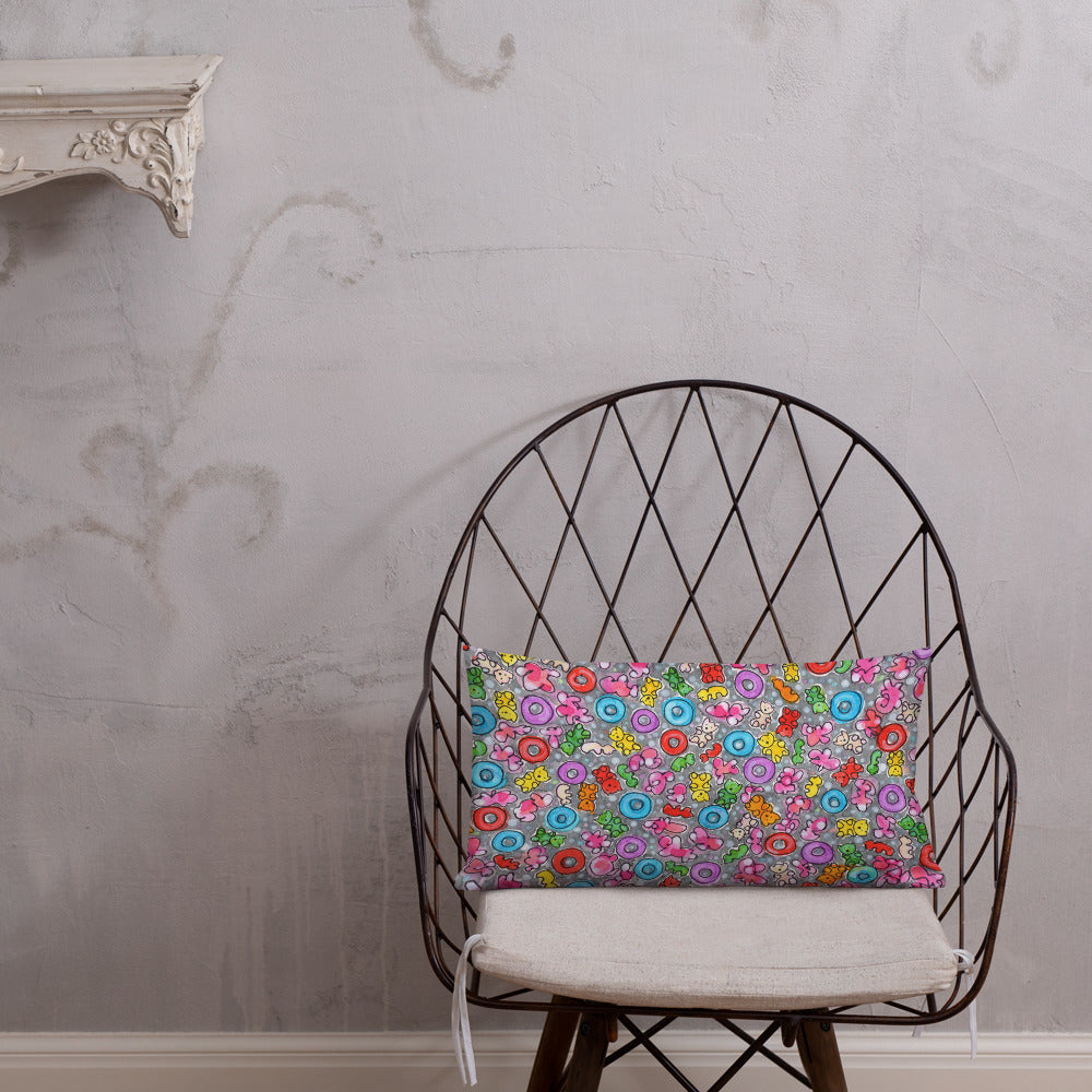 Vibrant, cheerful, and playful style accent pillow on modern chair with a multicolor graphic Popcornfroops print on front.