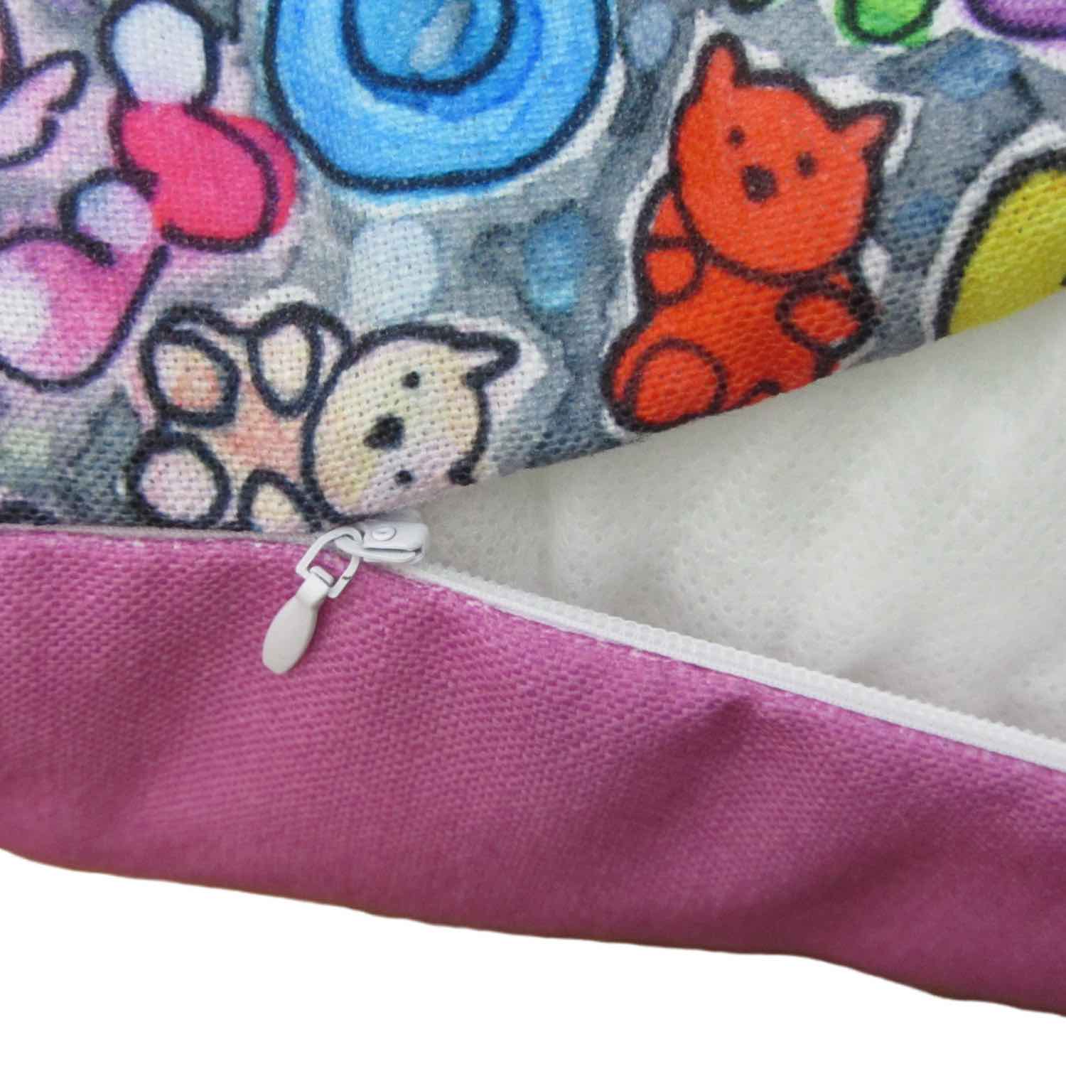 Detail of playful style accent pillow with a multicolor graphic Popcornfroops print and pink fabric, white zipper, and insert.