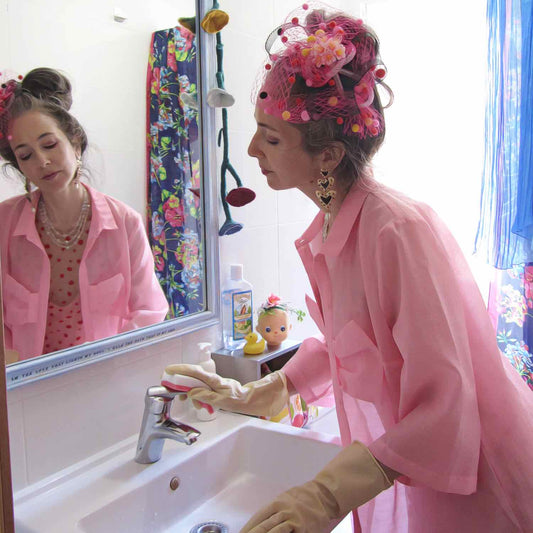 Alex Mitchell cleaning bathroom sink, all dressed up in pink with her misfit attitude about feeling fab whenever she wants.