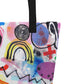 Close-up of black shoulder strap on multicolor Bazinga  print on front of graphic tote bag.