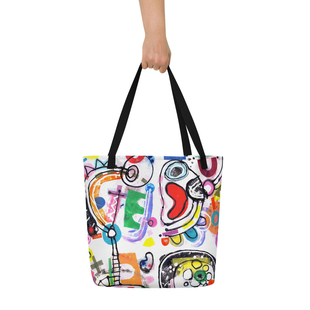Big sturdy graphic tote bag with multicolor Bonanza print on front and black straps held up with hand.