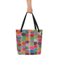Big sturdy graphic tote bag with multicolor Flipflop print on front and black straps held by hand.