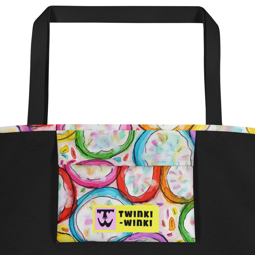 Inside pocket with multicolor Frosted Cookies print and black interior lining of graphic tote bag.