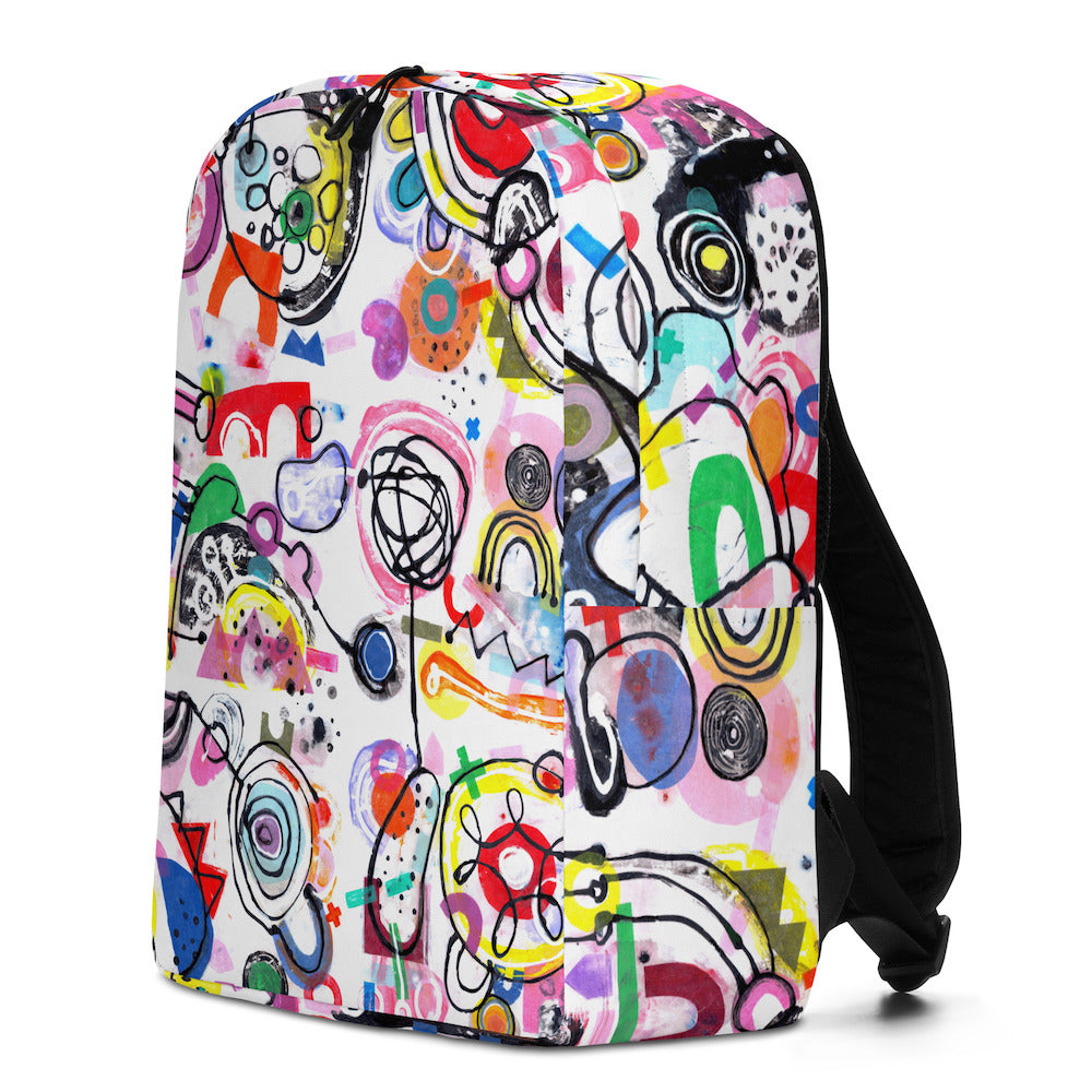 Graphic minimal design city style backpack with fun multicolor Treasure Map print and black shoulder straps, right side view.