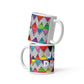 Two stacked colorful ceramic 11 ounce coffee mugs with quirky slogan Just Ducky in white letters on Zigzag design.