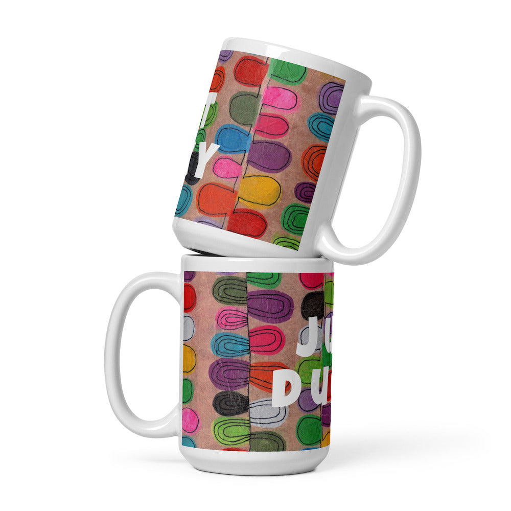 Two stacked colorful ceramic 15 ounce coffee mugs with quirky slogan Just Ducky in white letters on Flipflop design. 