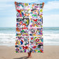 Stylish chic beach towel with bold multicolor Treasure Map print in a cheerful and playful style. Shown vertically and held by model.