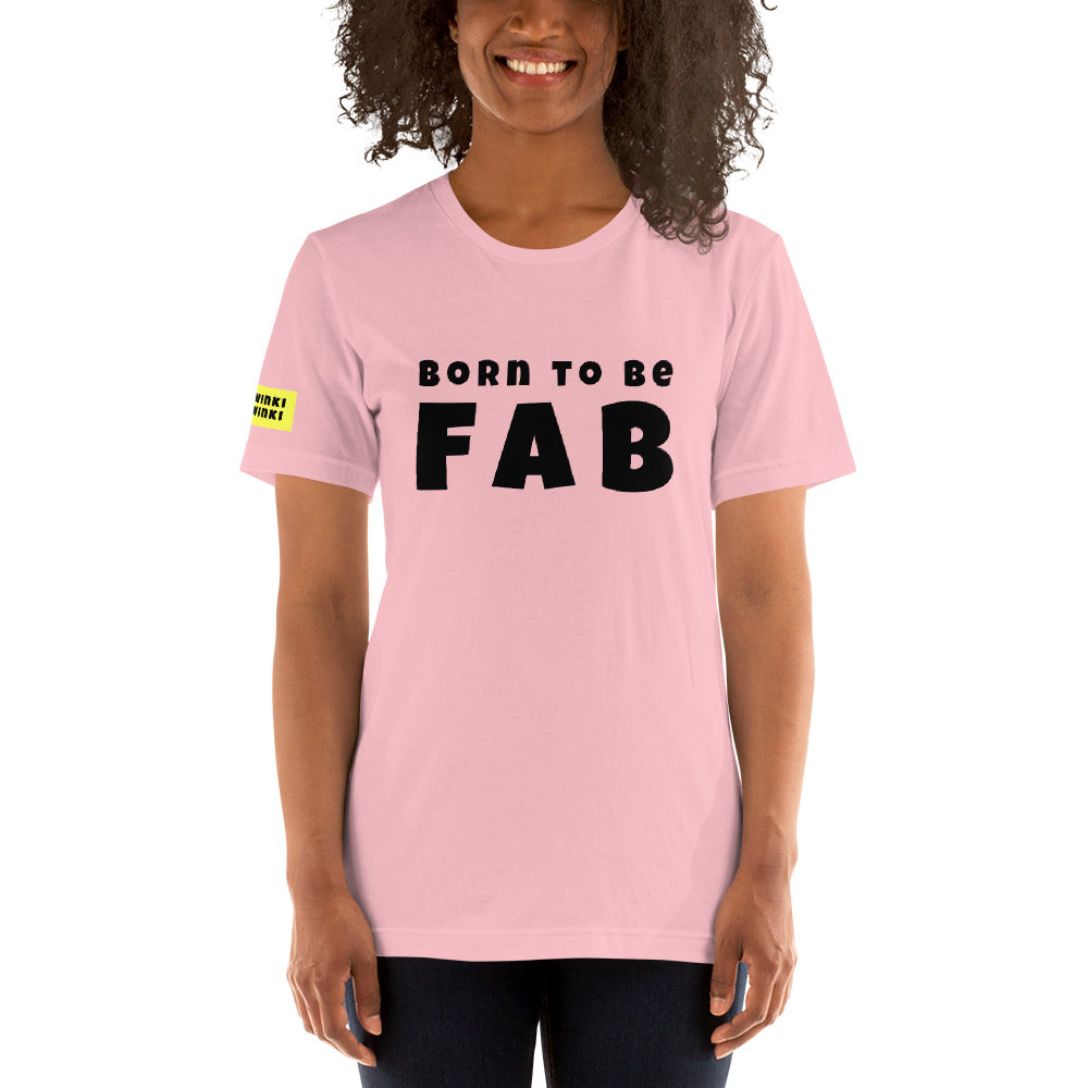 Young woman facing forward wearing cotton slogan tee in light pink color with slogan Born To Be Fab in black letters on front.