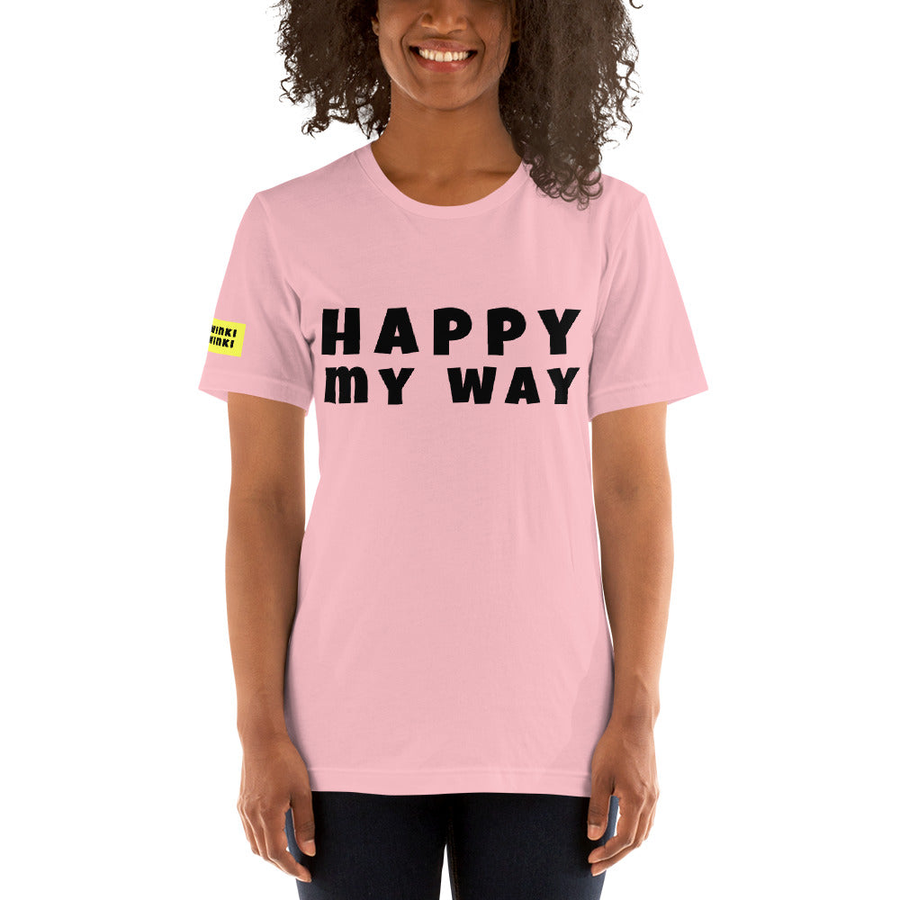Young woman facing forward wearing cotton slogan tee in light pink color with slogan Happy My Way in black letters on front.