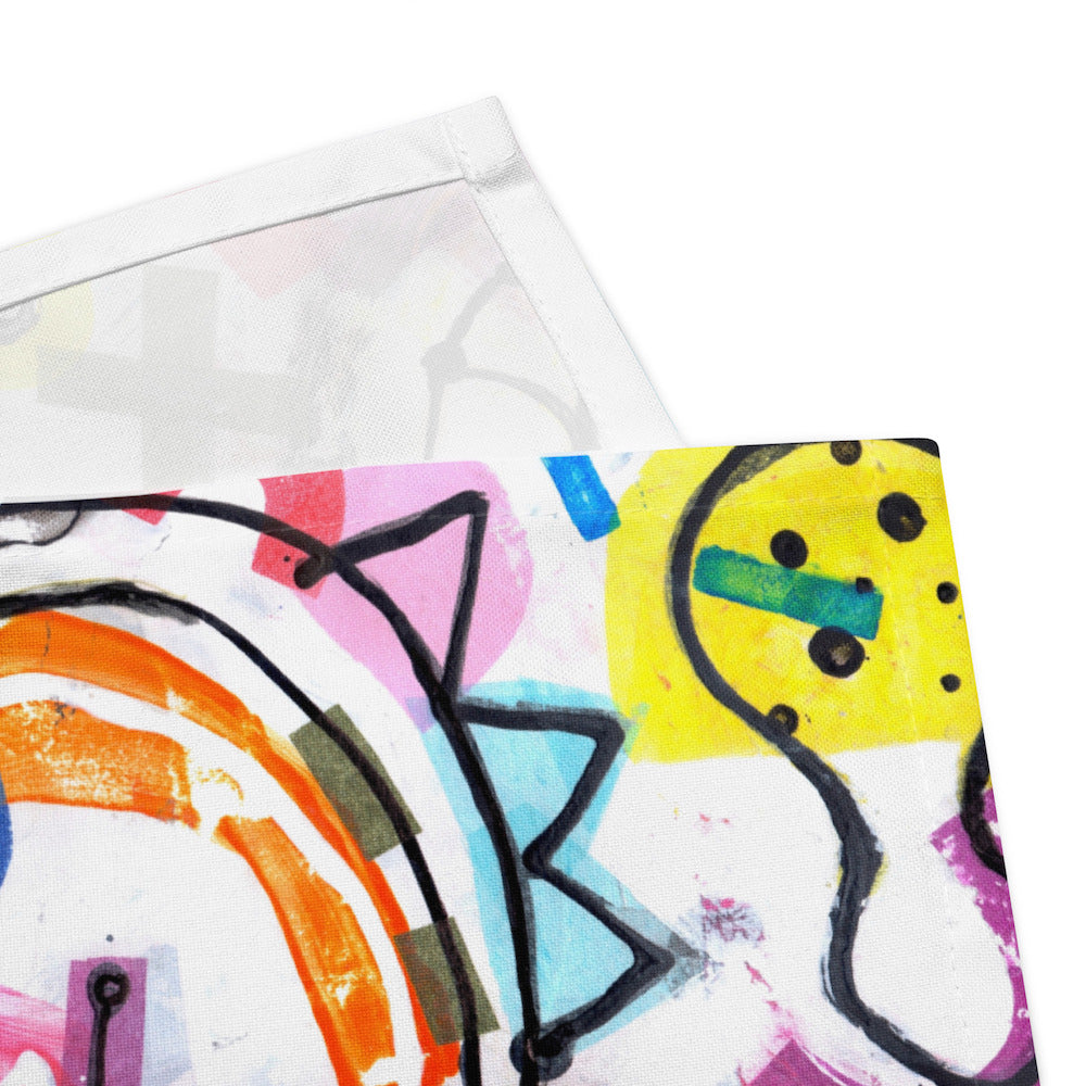 Arty graphic napkin with multicolor Treasure Map print in a vibrant, cheerful, and playful style. Detail of hem stitching on Design 1 of 4.