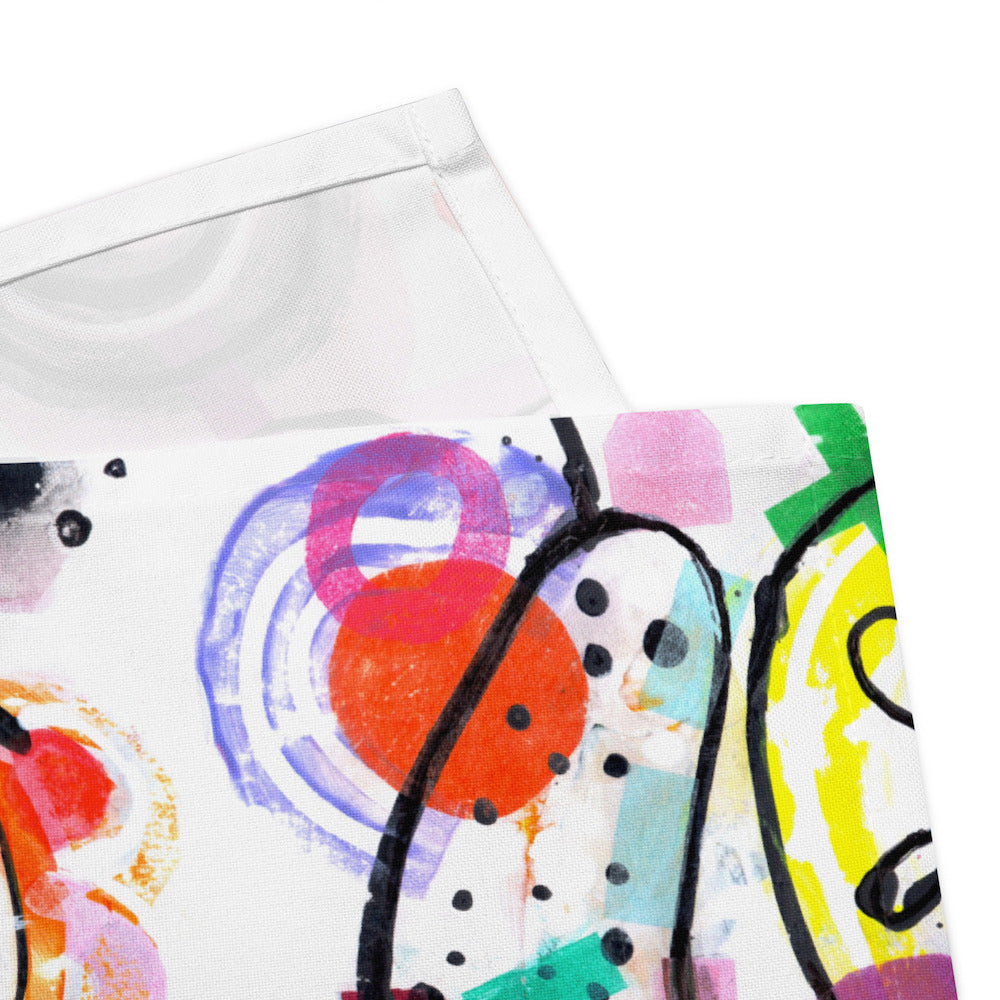 Arty graphic napkin with multicolor Treasure Map print in a vibrant, cheerful, and playful style. Detail of hem stitching on Design 4 of 4.