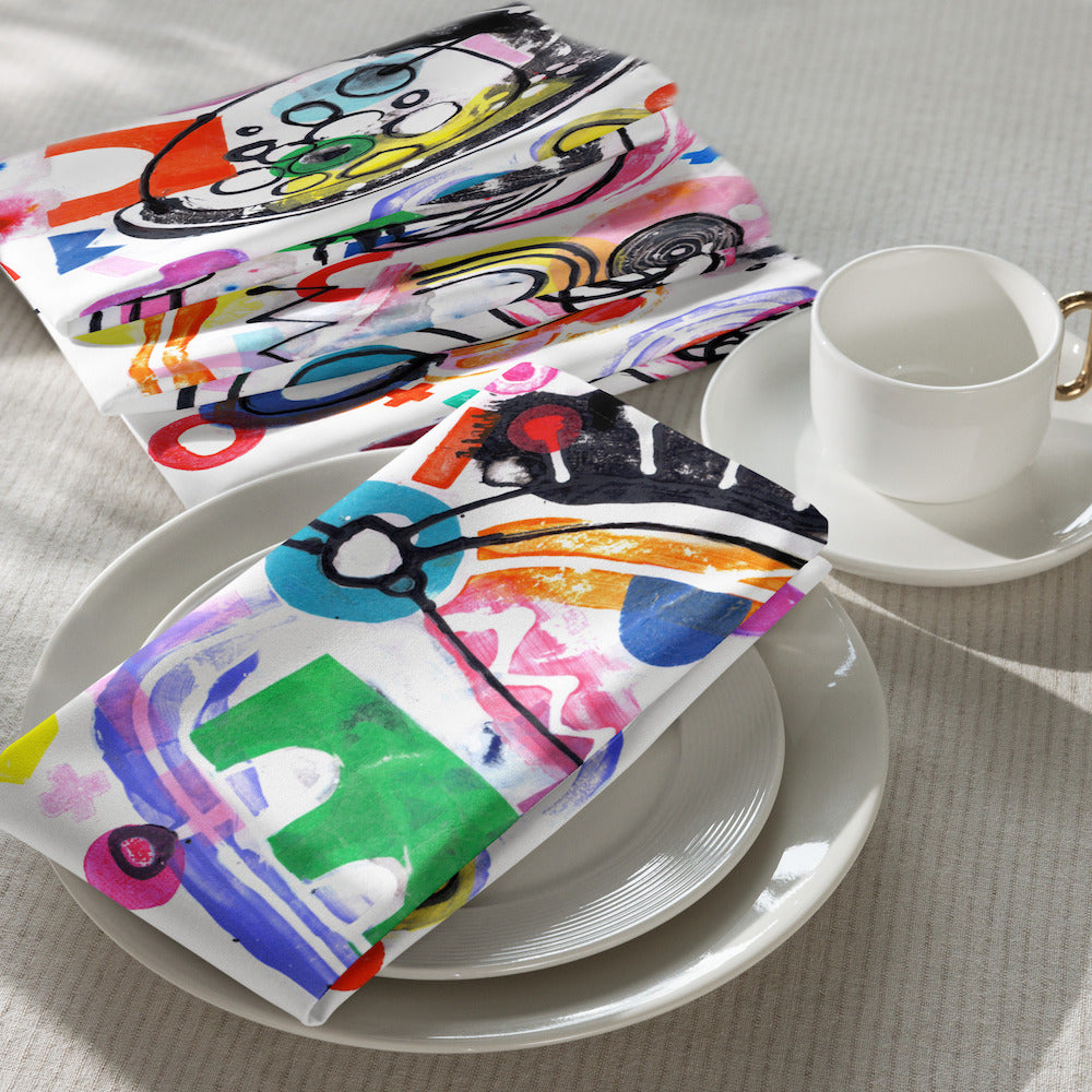 Arty graphic napkin set on white table setting with happy multicolor Treasure Map print in a vibrant, cheerful, and playful style.