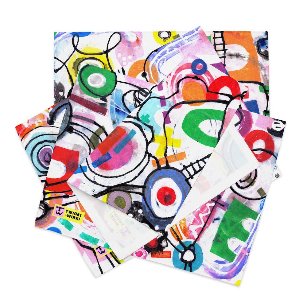 Arty graphic placemat set of four folded and stacked together with happy multicolor Treasure Map print in a vibrant, cheerful, and playful style.