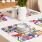 Arty graphic placemat set on white table setting with happy multicolor Treasure Map print in a vibrant, cheerful, and playful style.