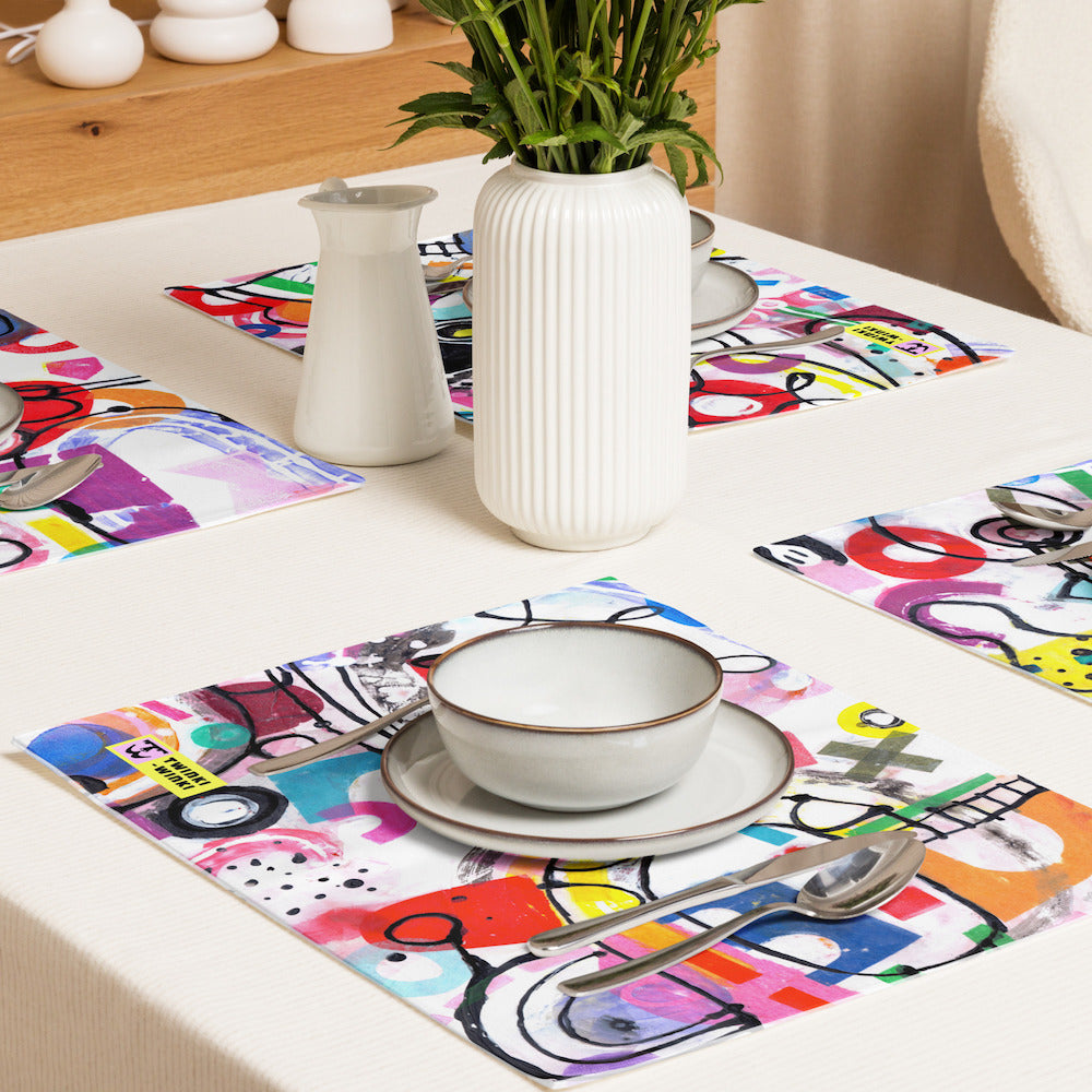 Arty graphic placemat set on white table setting with happy multicolor Treasure Map print in a vibrant, cheerful, and playful style.