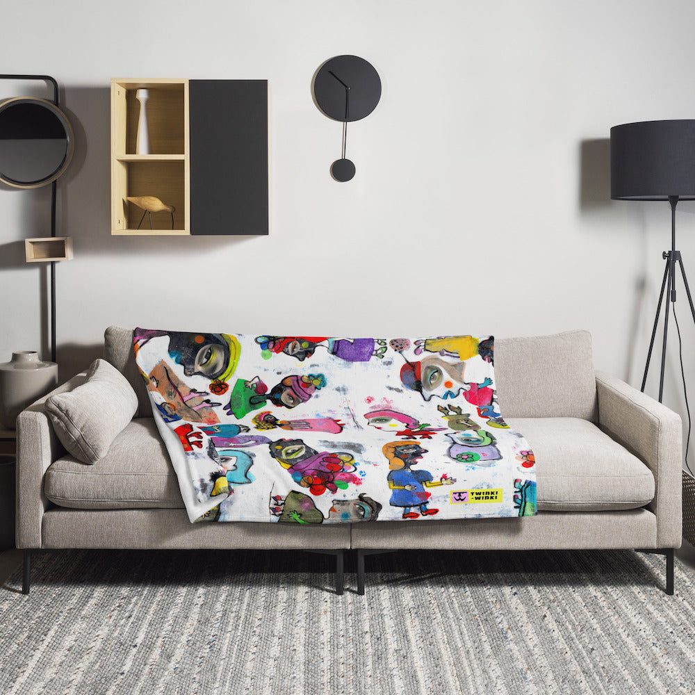 Stylish cozy graphic throw blanket with happy multicolor Fab Ladies print in a vibrant, cheerful, and playful style on beige sofa.