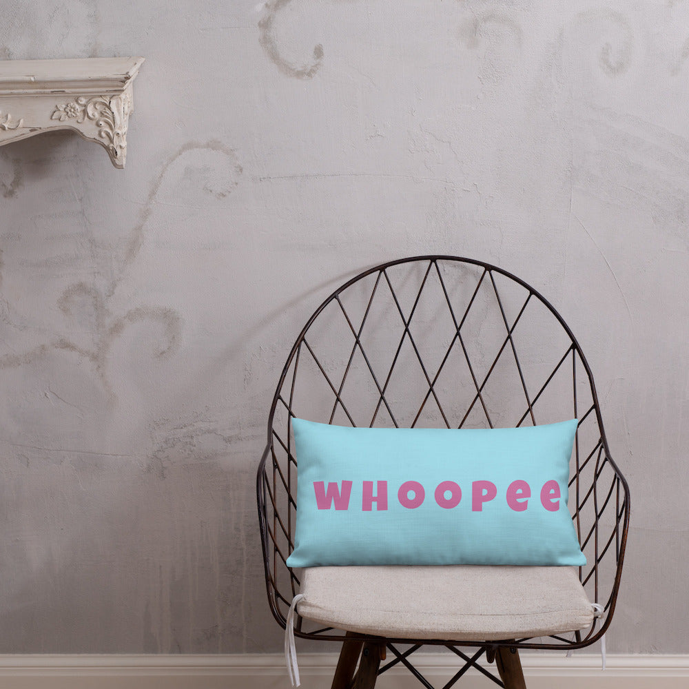 Vibrant, cheerful, and playful style accent pillow on modern chair with a fun Whoopee slogan in pink letters on cyan.