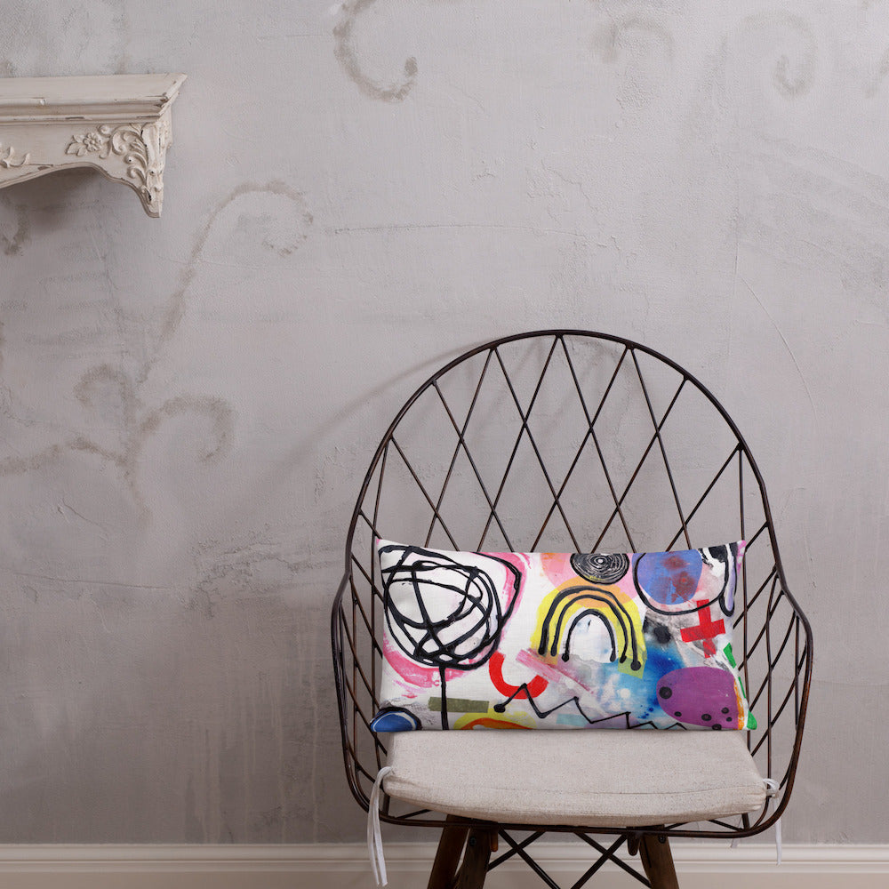 Vibrant, cheerful, and playful style accent pillow on modern chair with a multicolor graphic Eureka print on front.