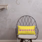 Vibrant, cheerful, and playful style accent pillow on modern chair with a fun Whoopee slogan in pink letters on yellow.