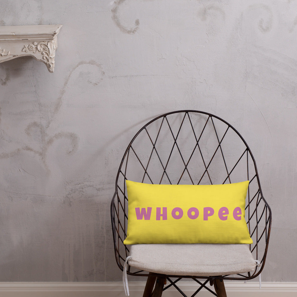 Vibrant, cheerful, and playful style accent pillow on modern chair with a fun Whoopee slogan in pink letters on yellow.