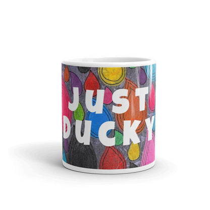 Colorful ceramic coffee mug with quirky slogan Just Ducky in white letters on Dripdrop design, front view of 11 ounce mug size.