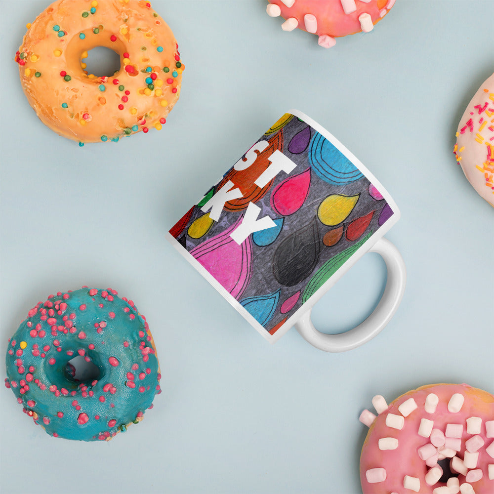 Colorful ceramic coffee mug with quirky slogan Just Ducky in white letters on Dripdrop design with happy donuts right view.