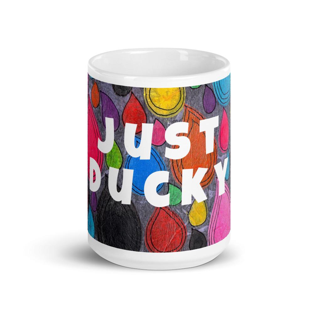 Big colorful ceramic coffee mug with quirky slogan Just Ducky in white letters on Dripdrop design, front view of 15 ounce mug size.