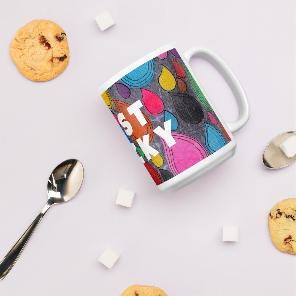 Colorful ceramic coffee mug with quirky slogan Just Ducky in white letters on Dripdrop design with cookies right view.
