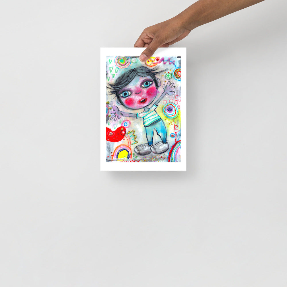 Colorful happy fine art print of a little boy surprised and excited on vibrant background hand held against wall to show size.