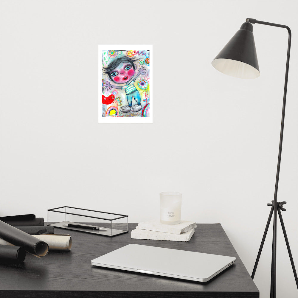 Colorful happy fine art print of a little boy surprised and excited on vibrant background hanging on wall at modern desk area.