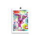 Colorful happy fine art print of a purple goat sticking out tongue on vibrant background hanging on wall from a binder clip.