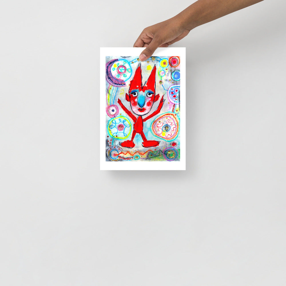 Colorful happy fine art print of a red devil pointing on vibrant background hand held against wall to show size.