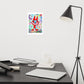 Detail of colorful happy fine art print of a red devil pointing on vibrant background hanging on wall at modern desk area.