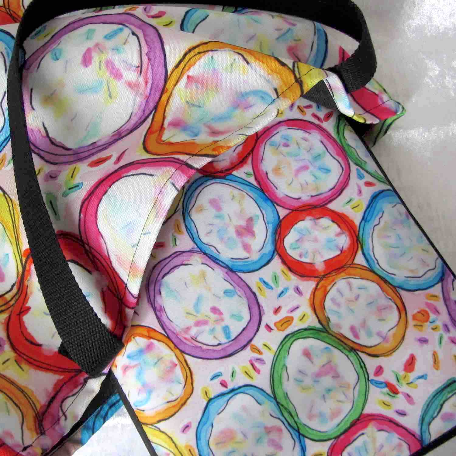 Graphic laptop case with rainbow-inspired multicolor Frosted Cookies print in vibrant colors with matching tote bag.