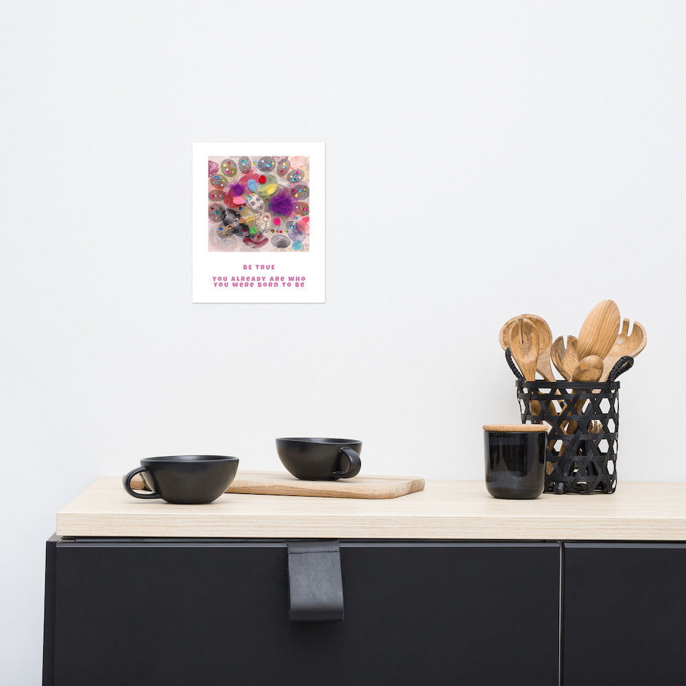 Fine art print Be True hanging on wall at stylish counter. Alex Mitchell’s happy face surrounded by colorful shapes and textures.