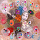 Detail of fine art print poster Love You. Alex Mitchell’s happy face is surrounded by colorful shapes and textures.