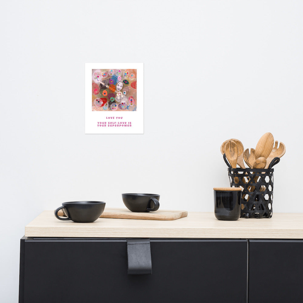 Fine art print Love You hanging on wall at stylish counter. Alex Mitchell’s happy face surrounded by colorful shapes and textures.