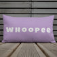Vibrant, cheerful, and playful style accent pillow on wood deck with a fun Whoopee slogan in platinum letters on violet.