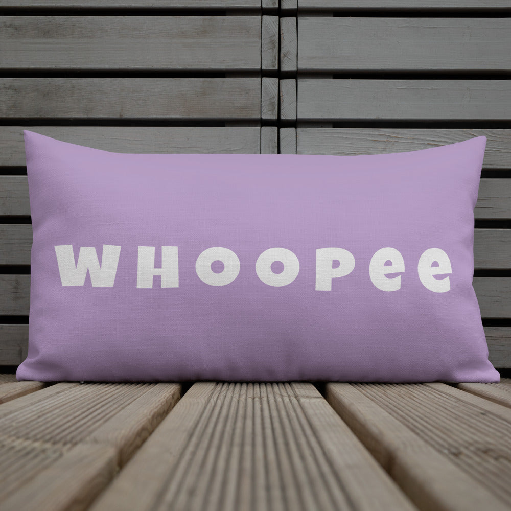 Vibrant, cheerful, and playful style accent pillow on wood deck with a fun Whoopee slogan in platinum letters on violet.