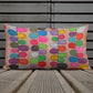 Vibrant, cheerful, and playful style accent pillow on wood deck with a multicolor graphic Flipflop print on front.
