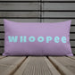 Vibrant, cheerful, and playful style accent pillow on wood deck with a fun Whoopee slogan in cyan letters on violet.